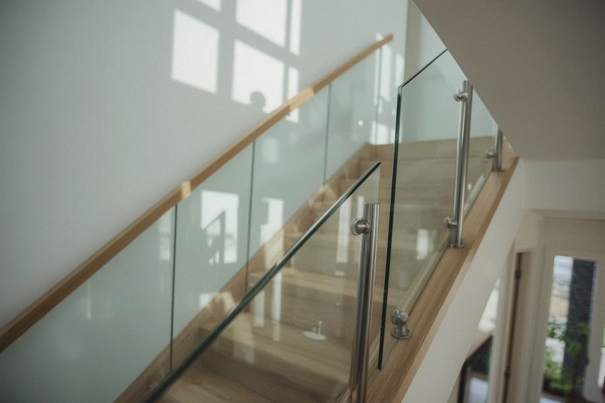 Glass stair railing panels mounted with stainless standoffs